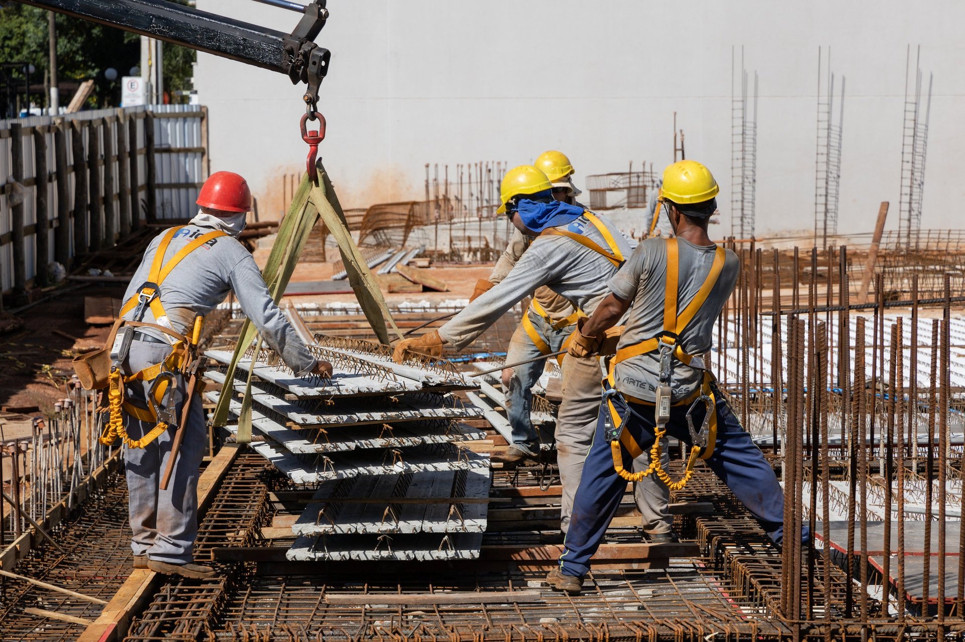 Men from the construction industry working on a building under construction placing slab pieces with steel and concrete