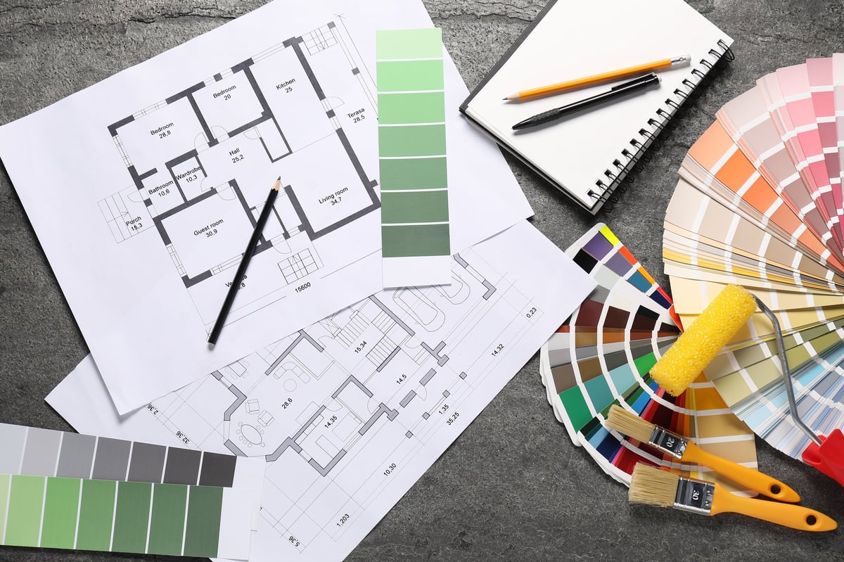 House plans and decorator tools on table