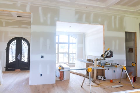 Modern living space during home renovation with unfinished walls and construction