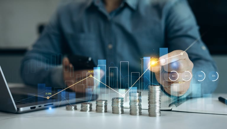 Stack of coins with growth graph representing financial success and investment profit