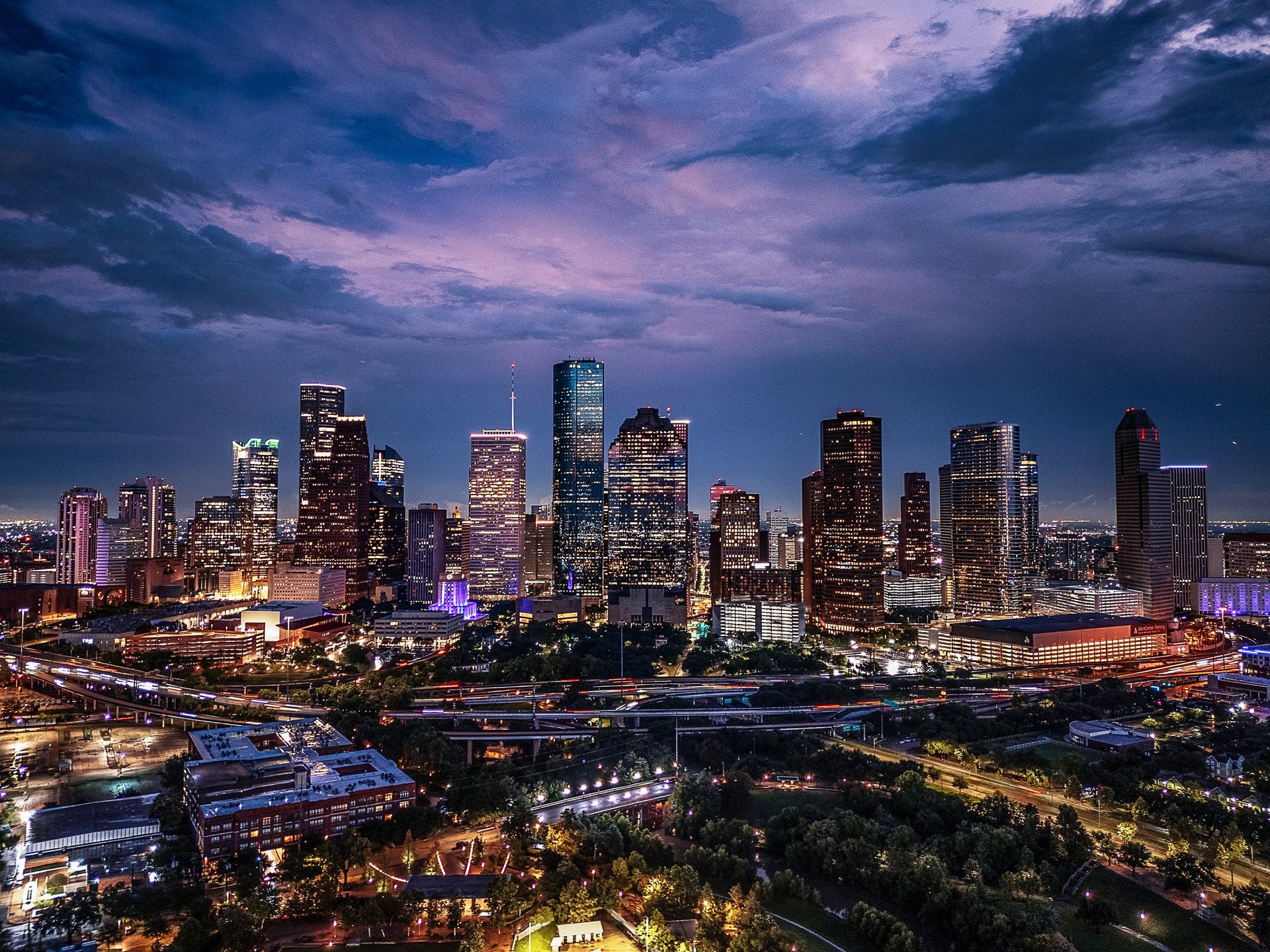Drone aerial image of downtown Houston, Texas captured at twilight with illuminated skyscrapers